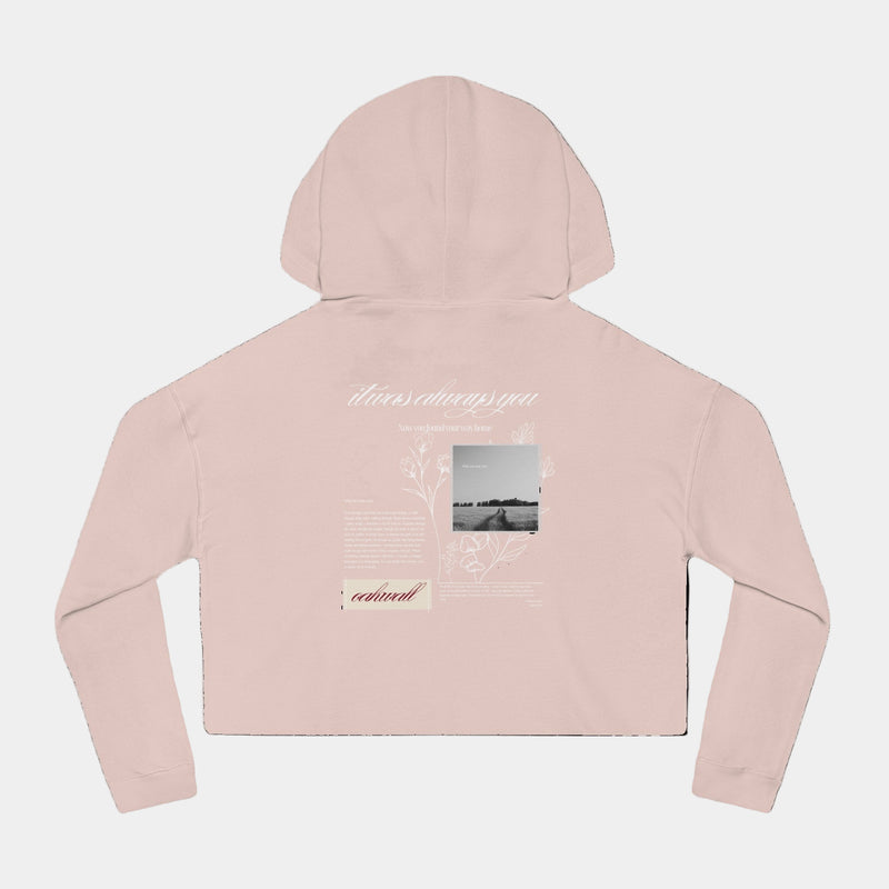 Pink hoodie with text and images on the back against a black background
